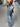 LIGHT BLUE FLARED JEANS WITH TRIBAL DESIGN AND SKINNY FIT BELT