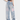 DISTRESSED LIGHT BLUE JEANS WITH SIZE CHART FOR EXPERT FIT GUIDANCE
