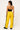 WOMAN'S BLACK HALTER TOP AND YELLOW TRACK PANTS FOR STREET STYLE